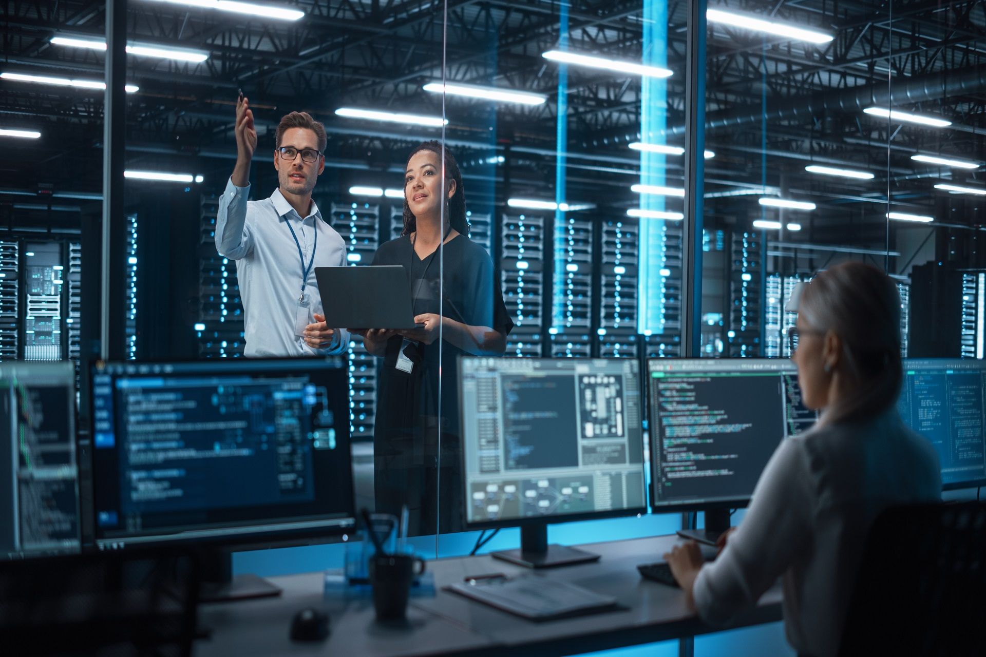 Team discussing IT solutions in server room