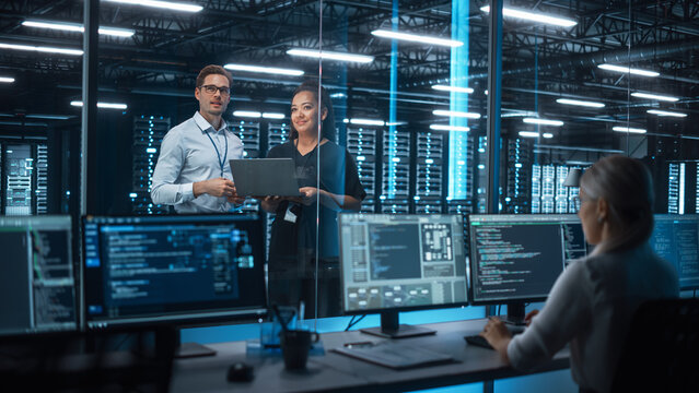 IT professionals discussing data in server room